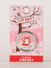 Load image into Gallery viewer, Classic Cherry Lip S**t by Blue Q | £7.50. All natural, vitamin E fortified lip balm. The lip balm is contained within a round metal tin with a sticker on the front depicting sweet fox meditating with the words “Lip Shit”.
