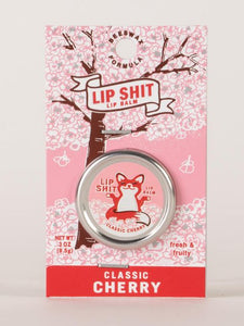 Classic Cherry Lip S**t by Blue Q | £7.50. All natural, vitamin E fortified lip balm. The lip balm is contained within a round metal tin with a sticker on the front depicting sweet fox meditating with the words “Lip Shit”.
