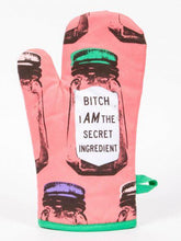 Load image into Gallery viewer, Bitch I am the Secret Ingredient Oven Mitt by Blue Q.  Background is pink and the design features classic condiment shaped jars with one centrally positioned with a large label reading “”Bitch i AM the secret ingredient “. There is a tag on obe side for hanging.
