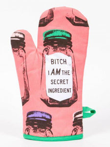 Bitch I am the Secret Ingredient Oven Mitt by Blue Q.  Background is pink and the design features classic condiment shaped jars with one centrally positioned with a large label reading “”Bitch i AM the secret ingredient “. There is a tag on obe side for hanging.