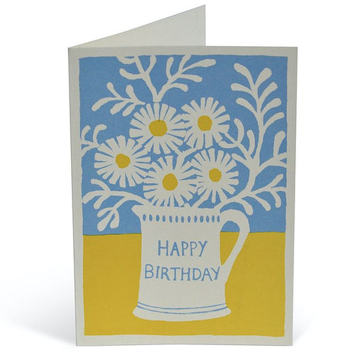 Simple design in fresh blue and yellow of a simple print of a bunch of daisies in a jug with the words Happy Birthday on it.