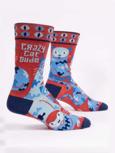 Load image into Gallery viewer, Crazy Cat Dude Men’s crew Socks by Blue Q | £11.95. Ethical and sustainable socks with quirky, humorous designs and vibrant colours. This design is in red with blue abstract cats and different coloured cat eyes with the words “Crazy Cat Dude” above. 
