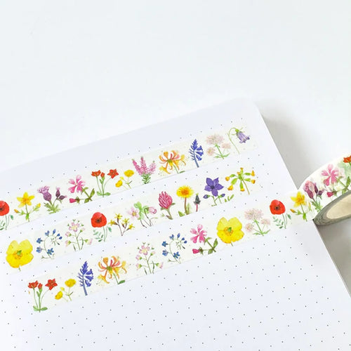 white washi tape with delicate watercolour illustrations of common British wildflowers along it, including common, poppy, forget-me-not, welsh poppy, cowslip, red campion and many more