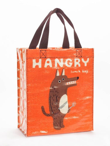 Handy tote bag for carrying your lunch.  Burnt orange background with funny looking fox or bear ( we’re not quite sure) holding a knife and fork and bearing its teeth.  The word “Hangry” is written in large cream capital letters across the top of the bag, and written smaller underneath reads “lunch bag”. The handles are made of black webbing.
